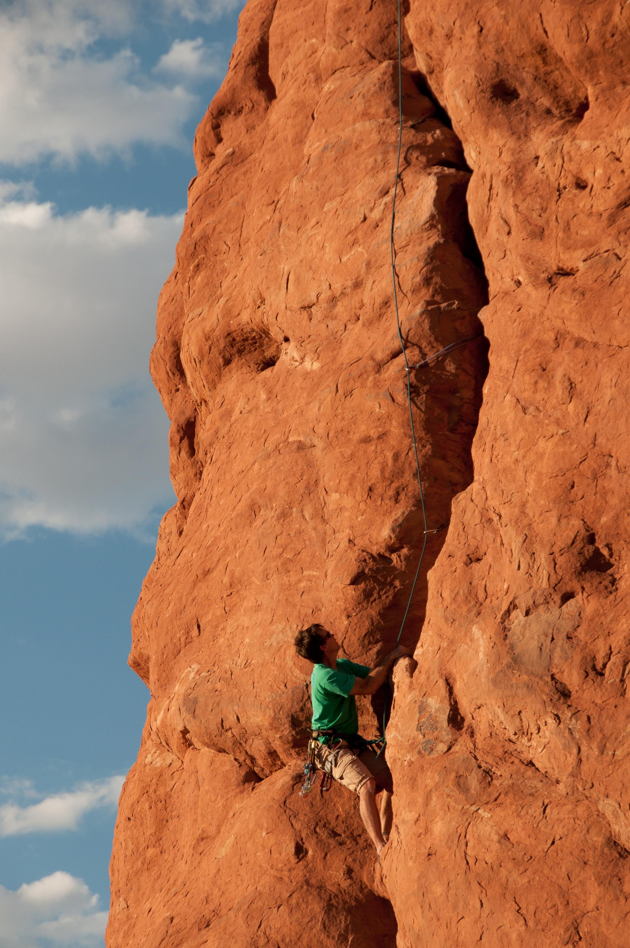 Climber ascends a crack in red sandstone