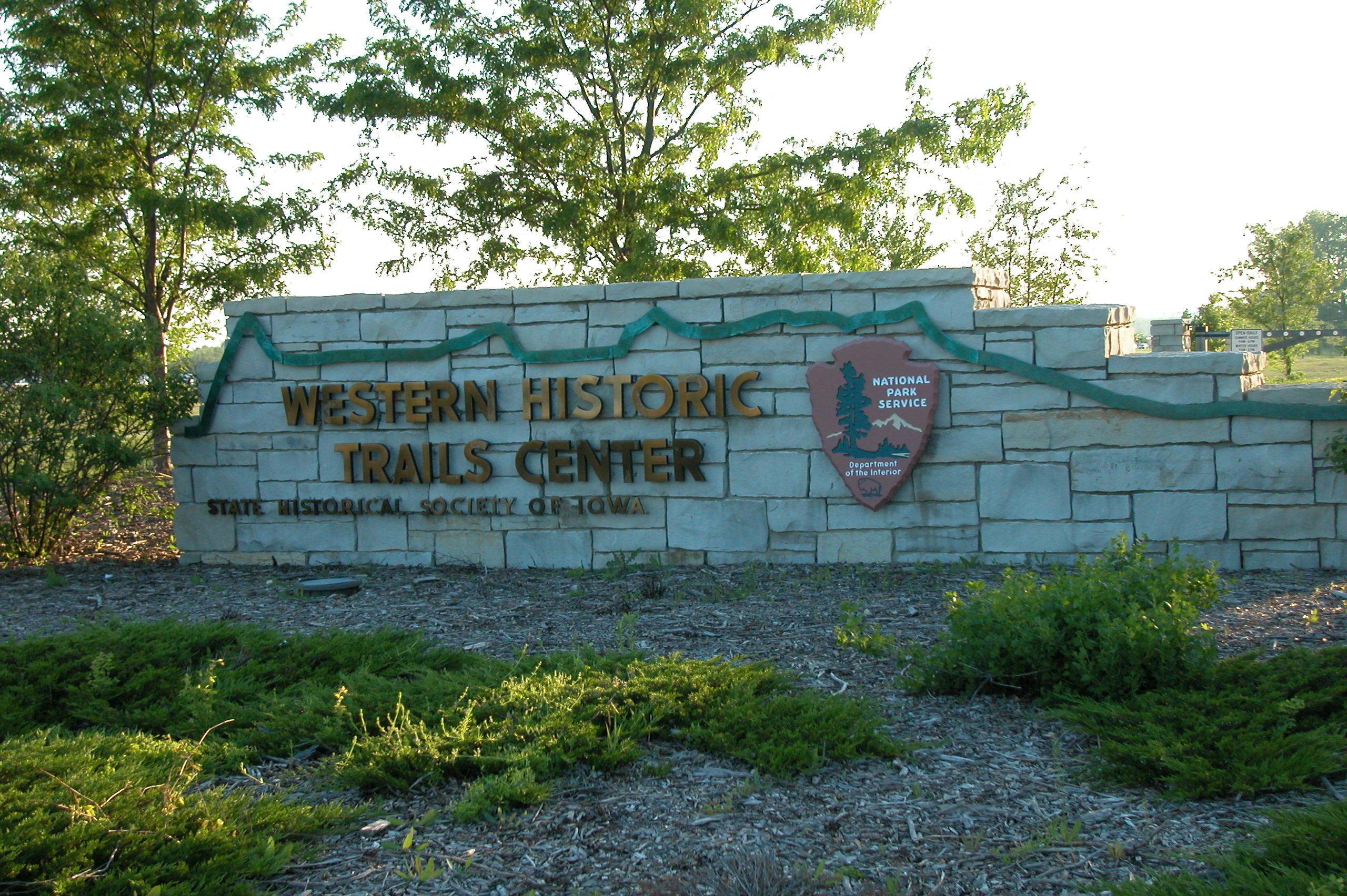 A stone sign with the entrance to the visitor center.