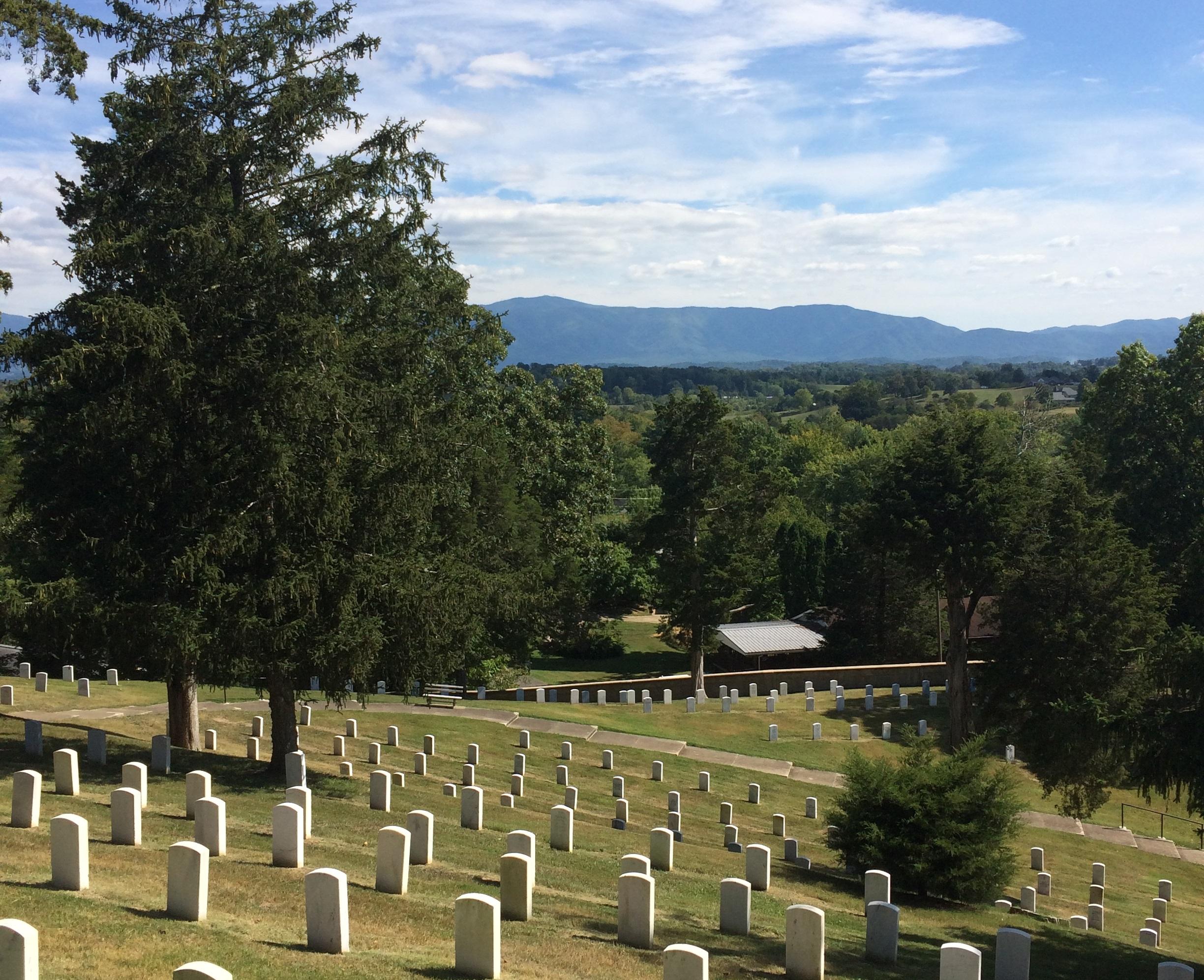 A view of veteran headstones with the Appalachian mountains in the distance