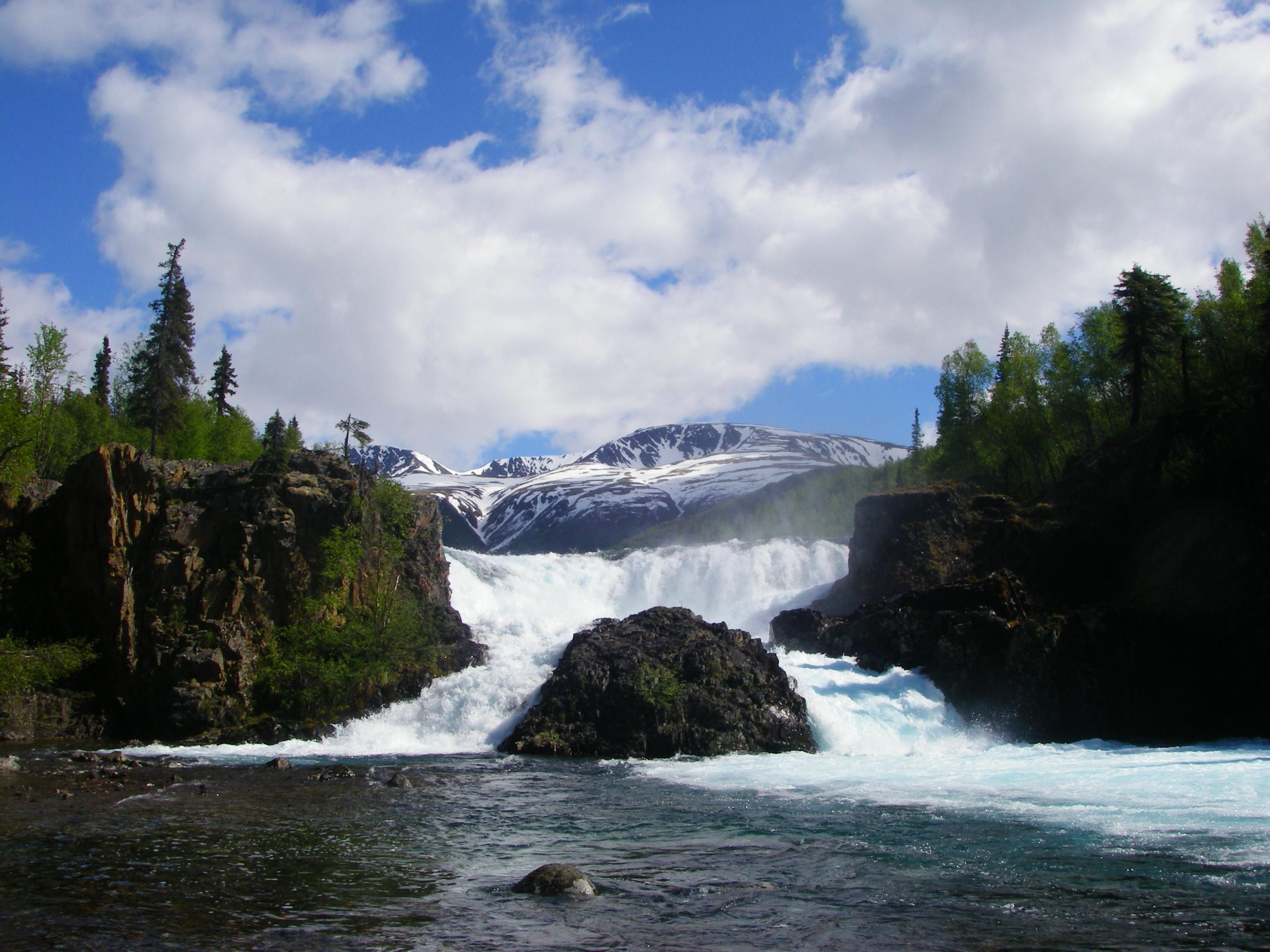 A raging water fall on a sunny day