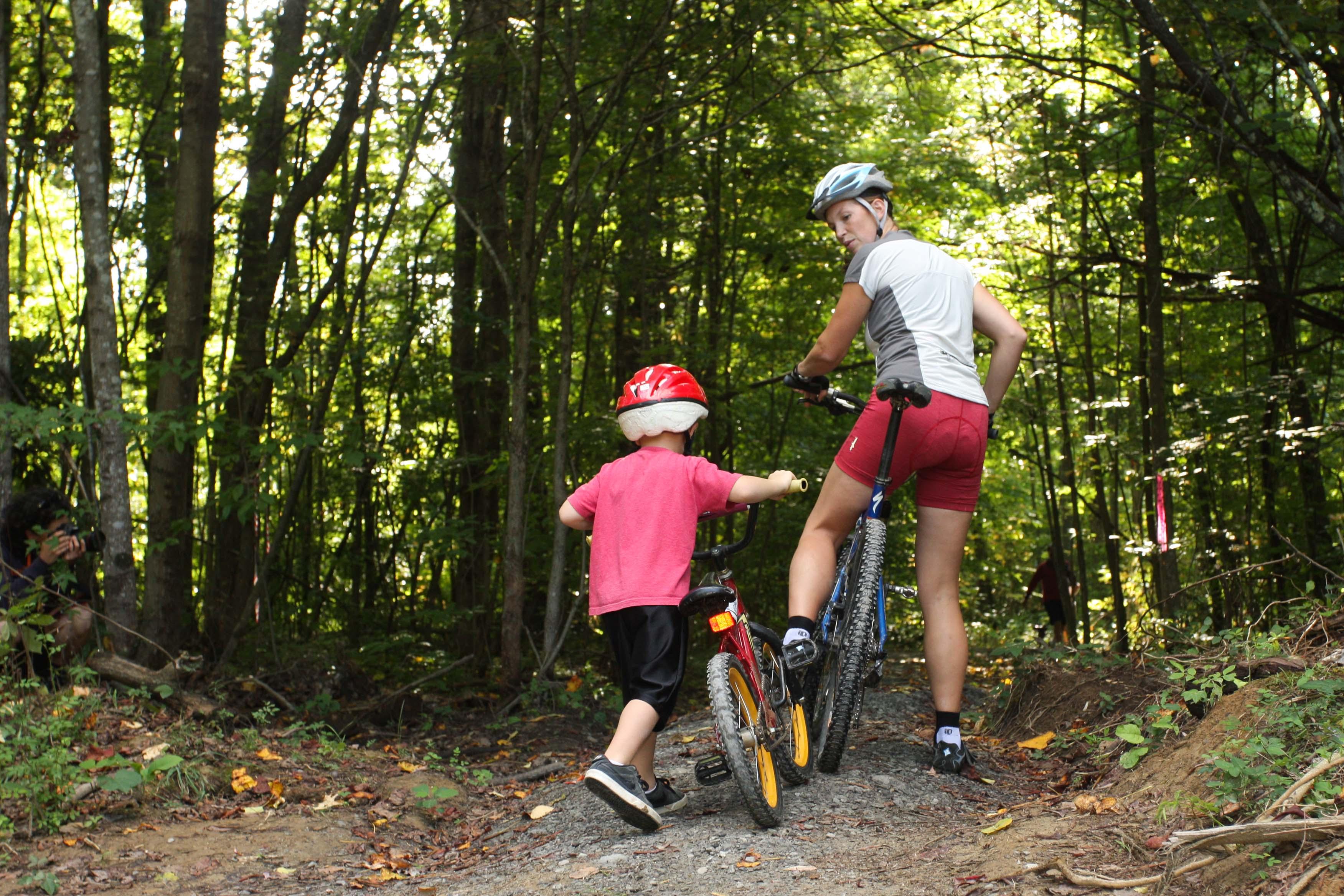 mother and child riding bikes on a trail