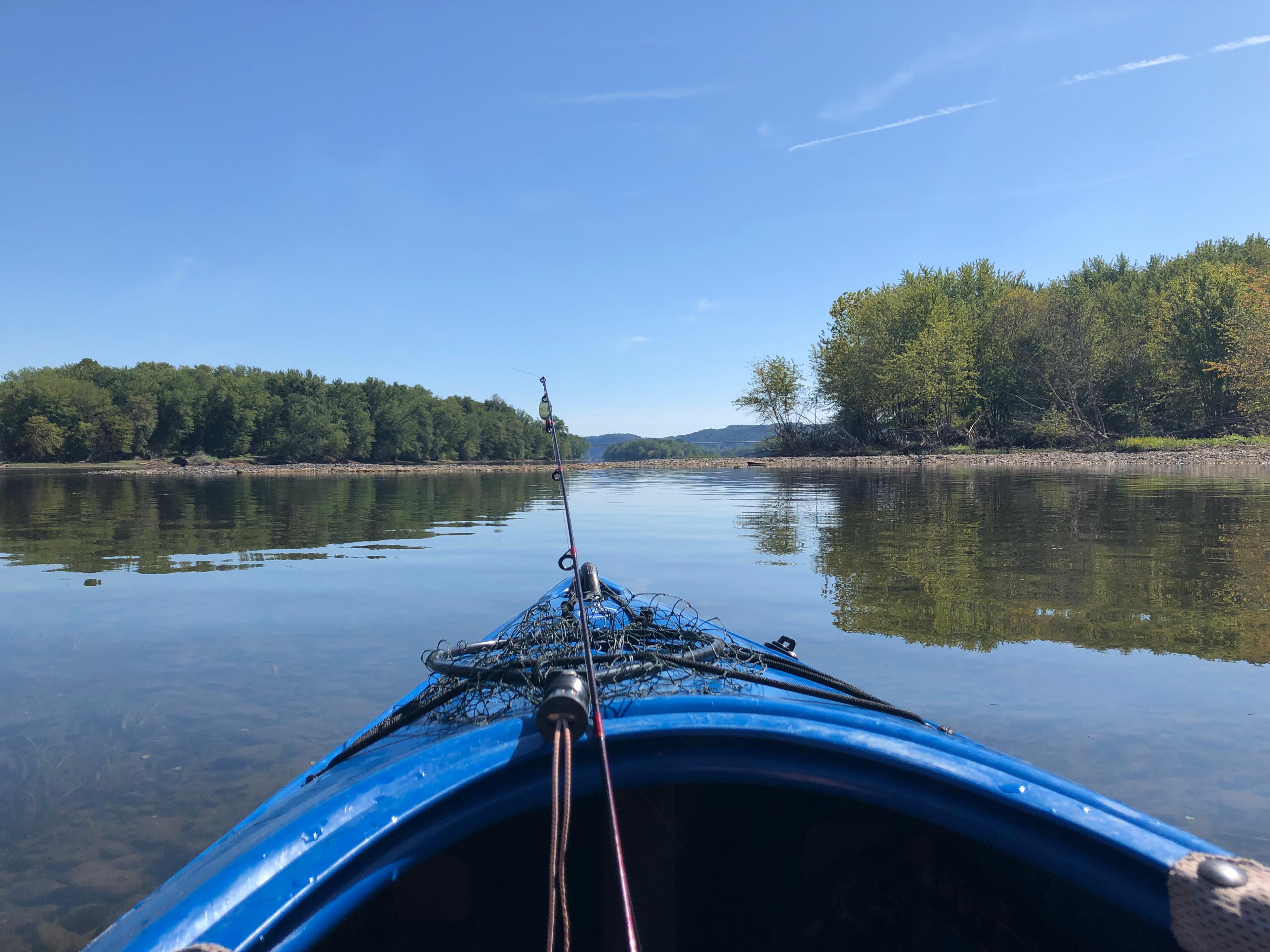 Blue kayak on calm, reflective waters