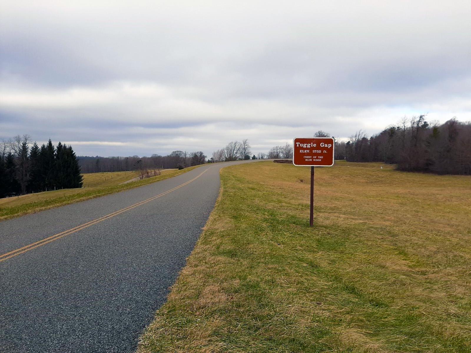 A view of Tuggle Gap with a sign reading "Tuggle Gap, Elev 2752, Crest of the Blue Ridge".