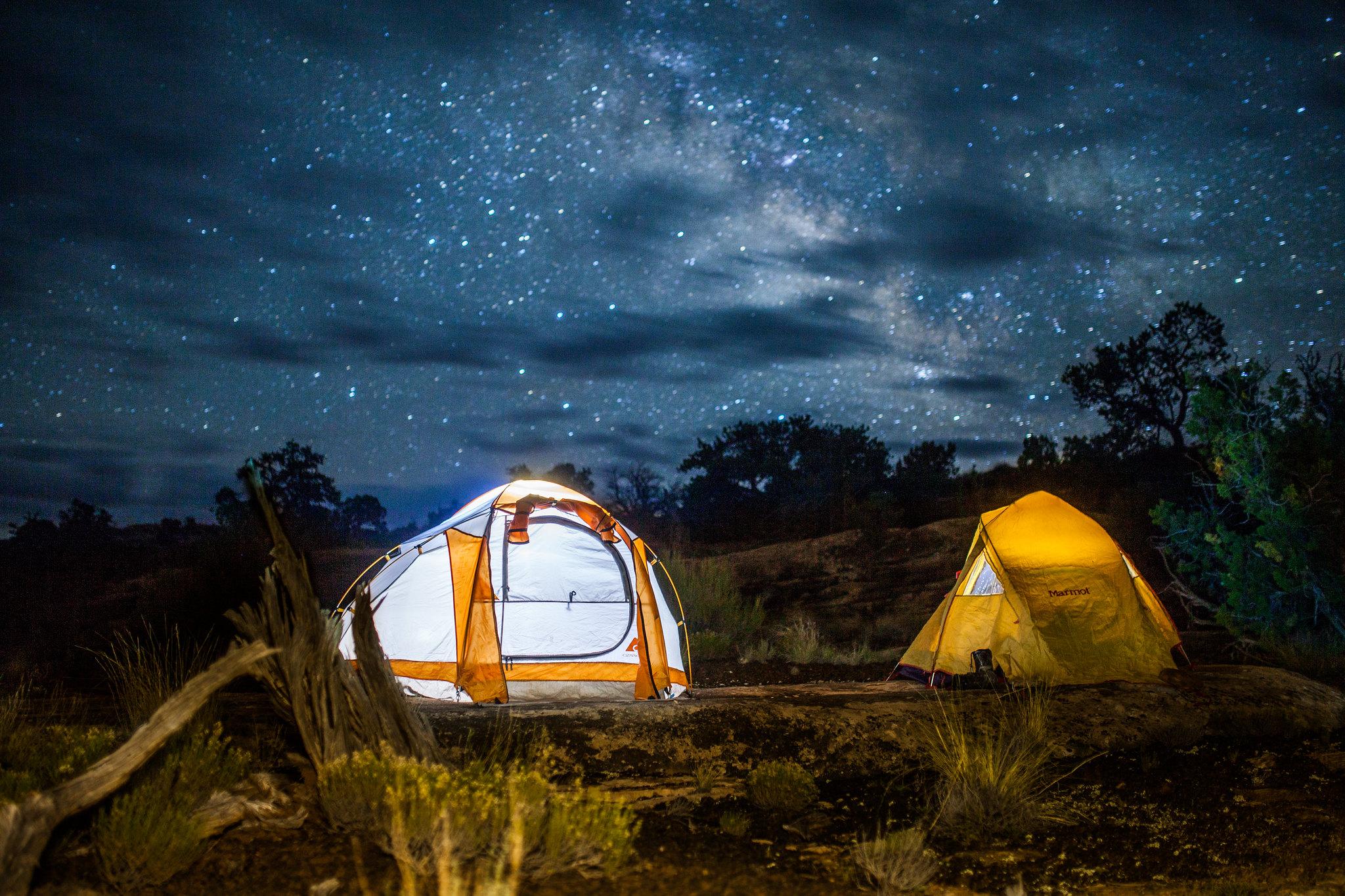 Two white and yellow tents illuminated the stars