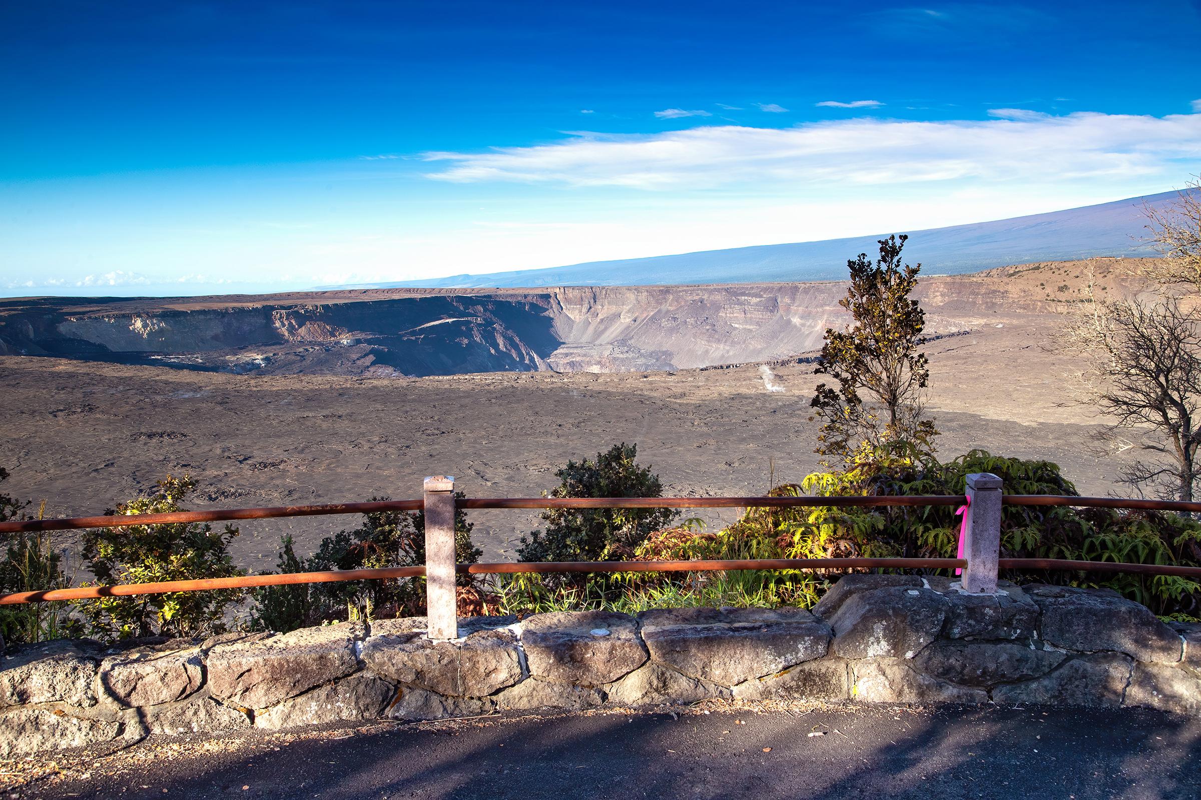 Overlook into a volcanic crater with trees in the foreground