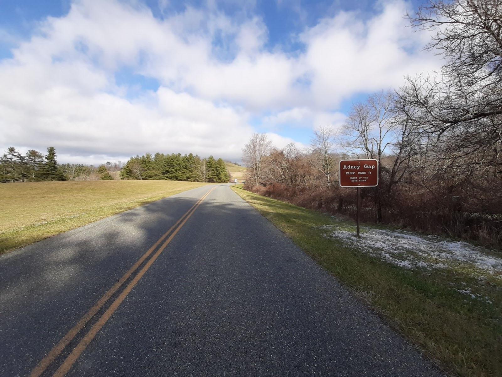 View of the parkway at Adney Gap. Sign reads, Adney Gap ELEV. 2960 ft. Crest of the Blue Ridge