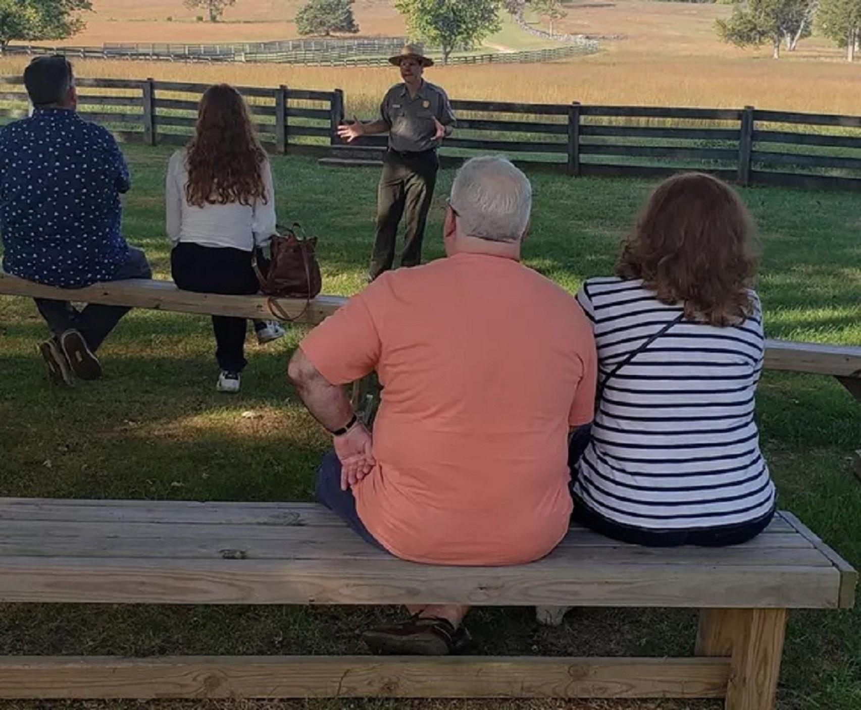 A ranger stands in front of a seated crowd.