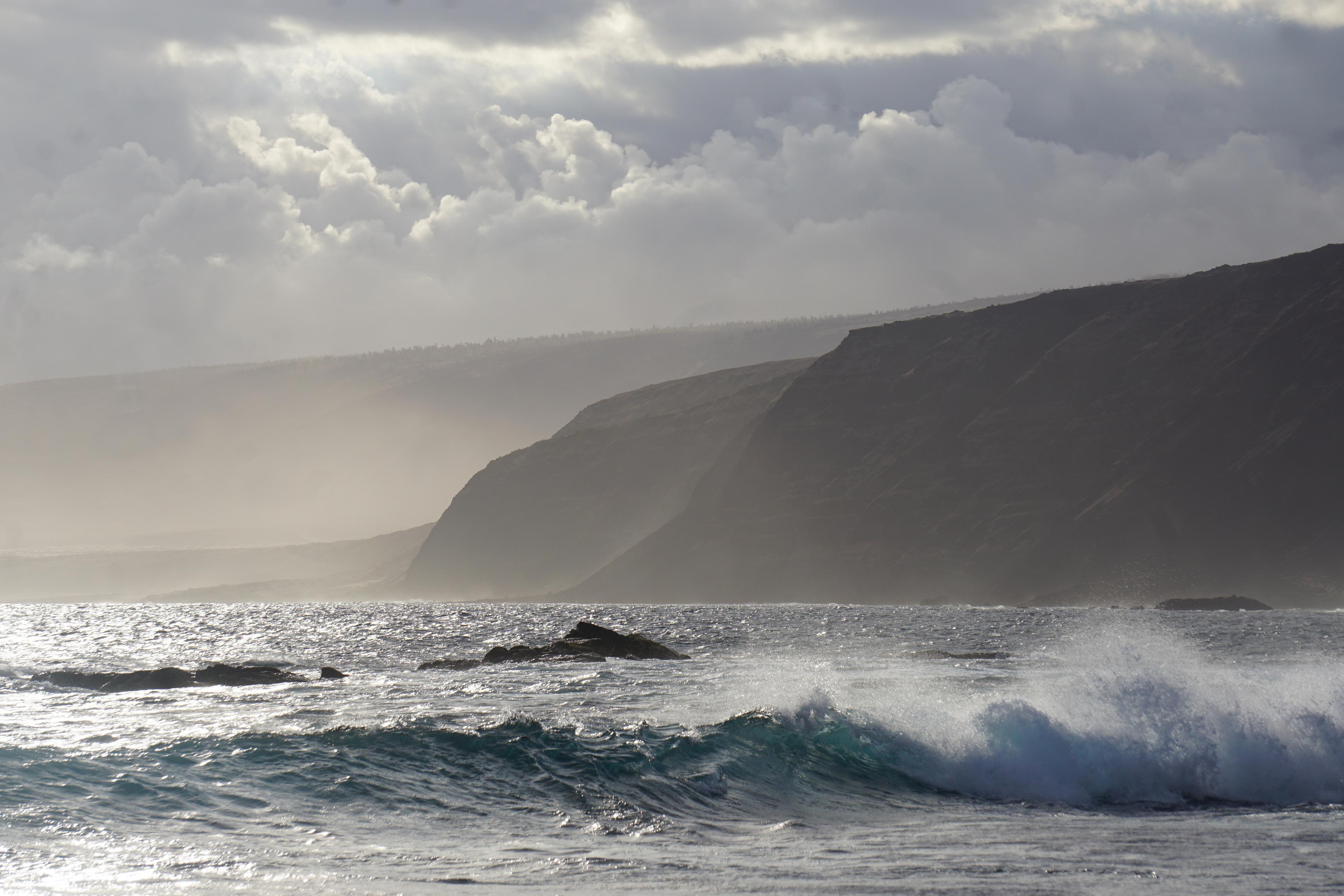 Ocean waves and coastal cliffs shortly before sunset