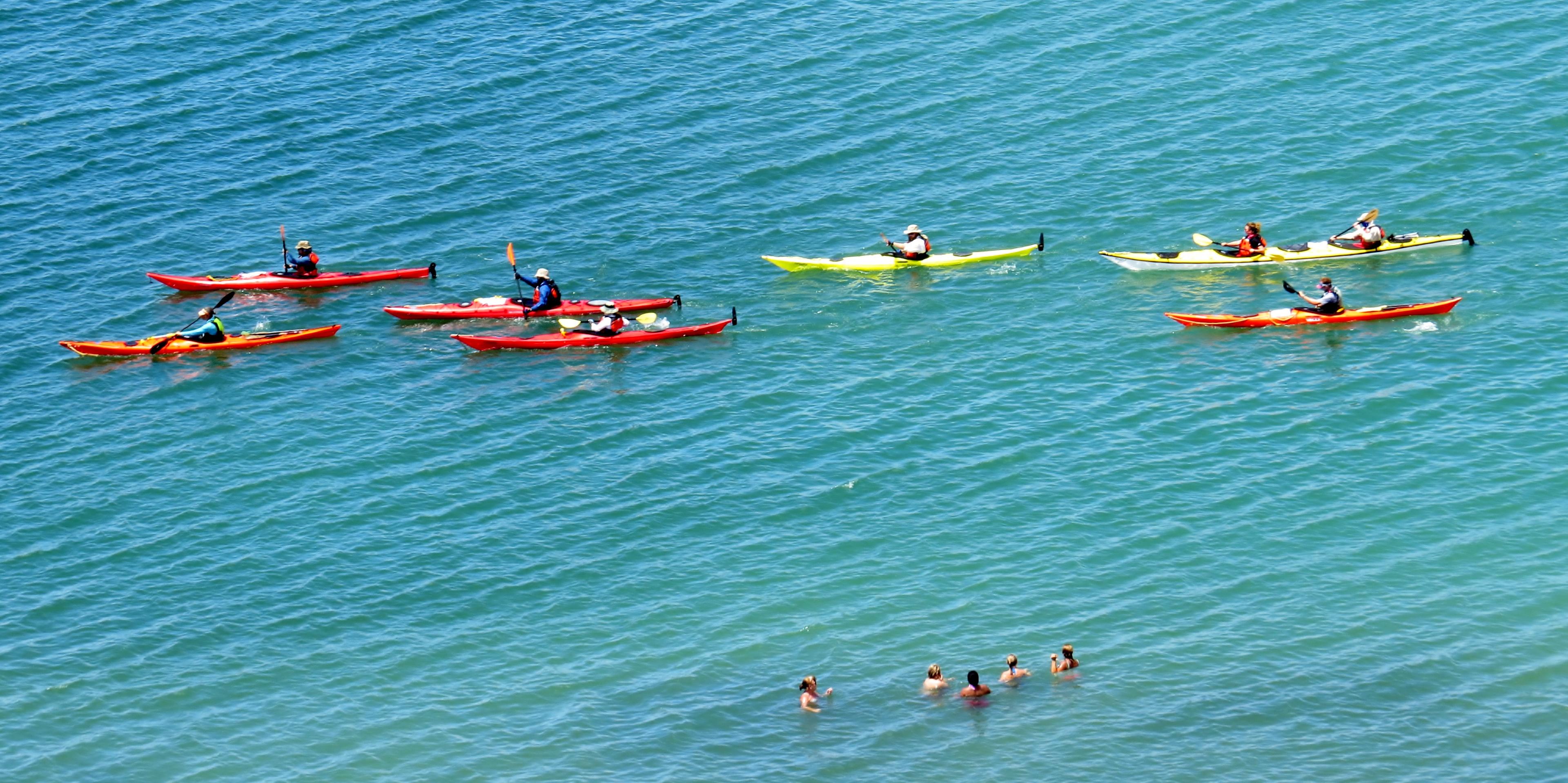 A group of kayakers paddle through the sound at Cape Lookout National Seashore.