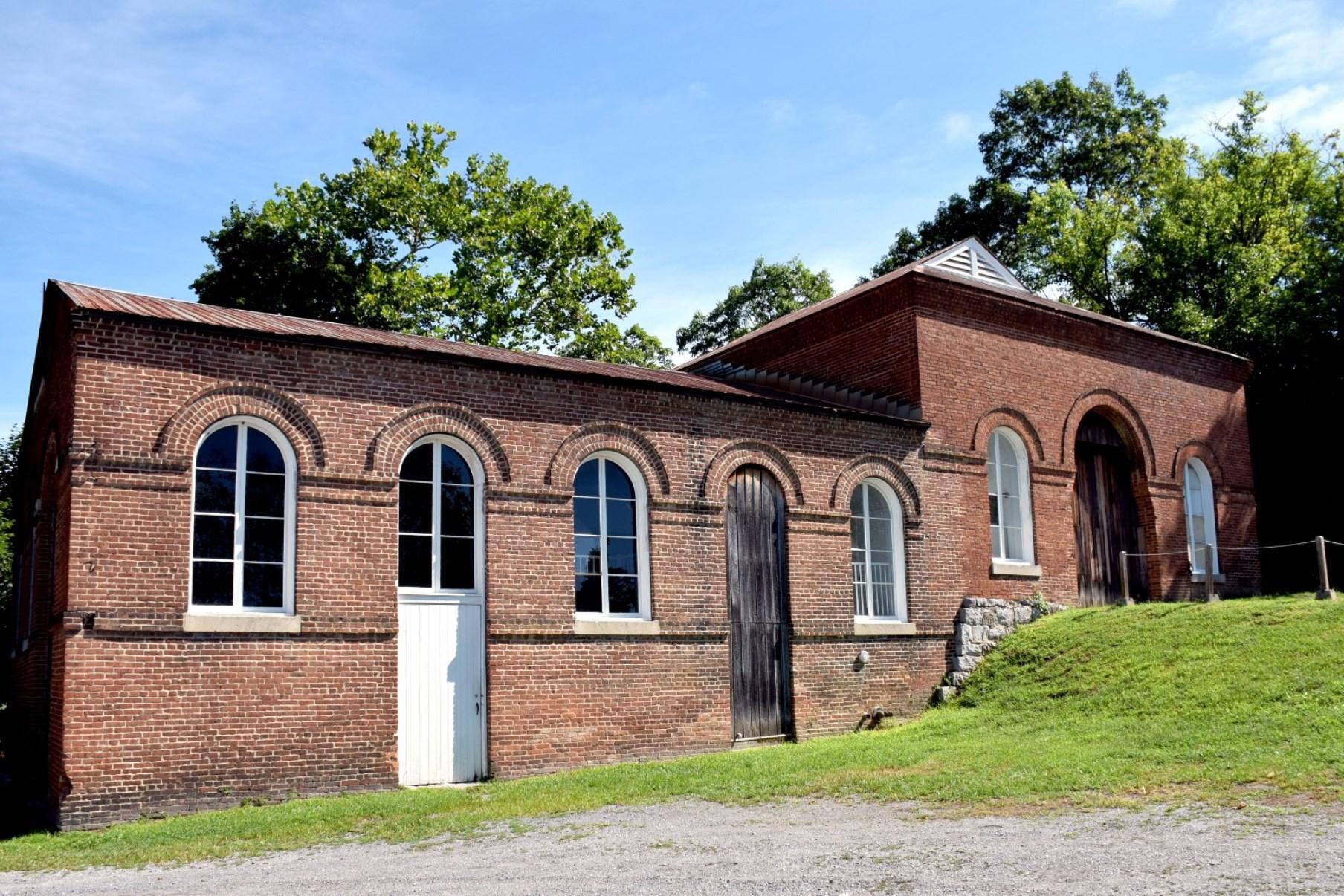 Image of large brick trolley barn viewed from the front