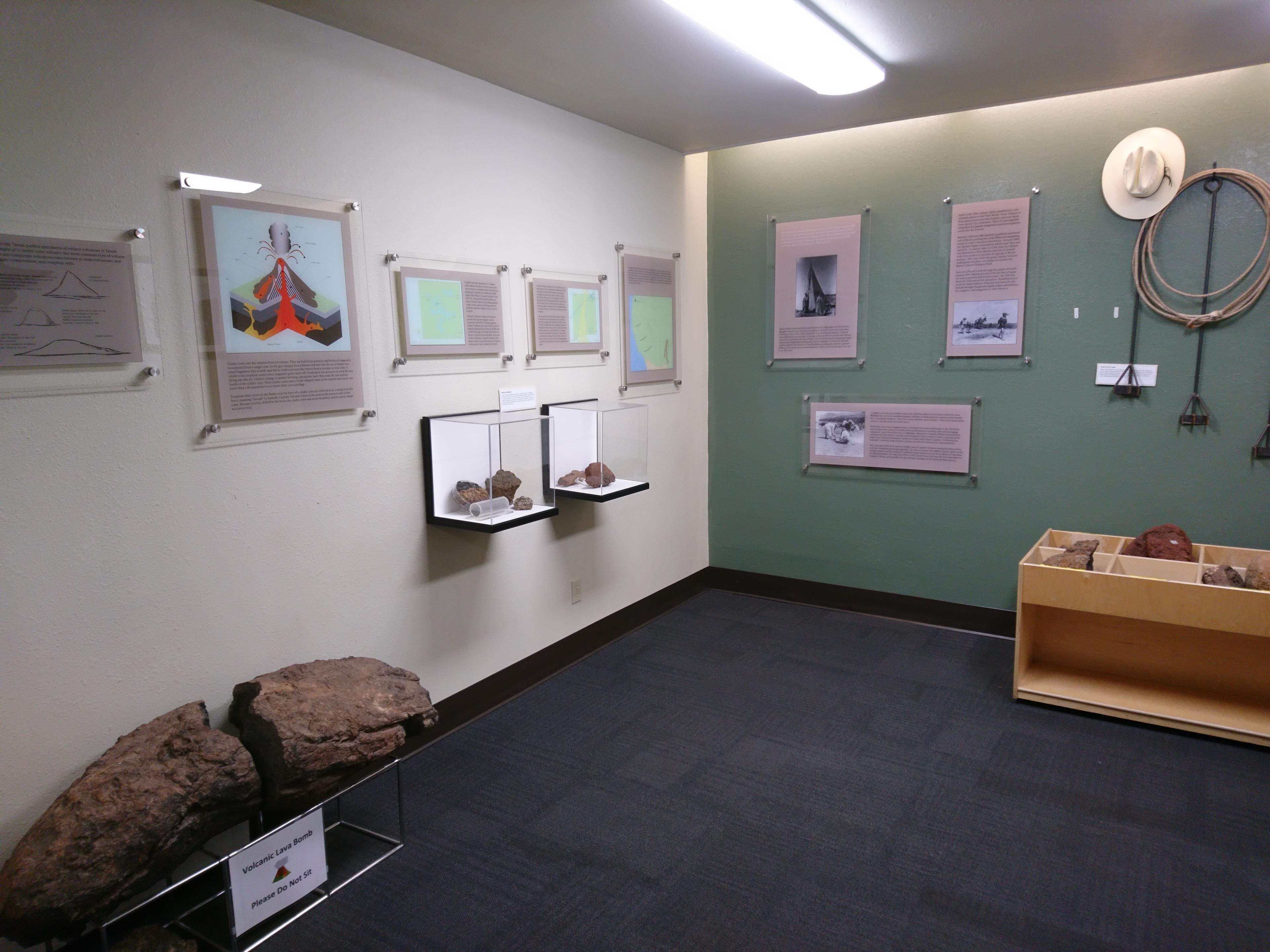 Exhibits in the Visitor Center with a large volcanic bomb on the left and touch table on the right