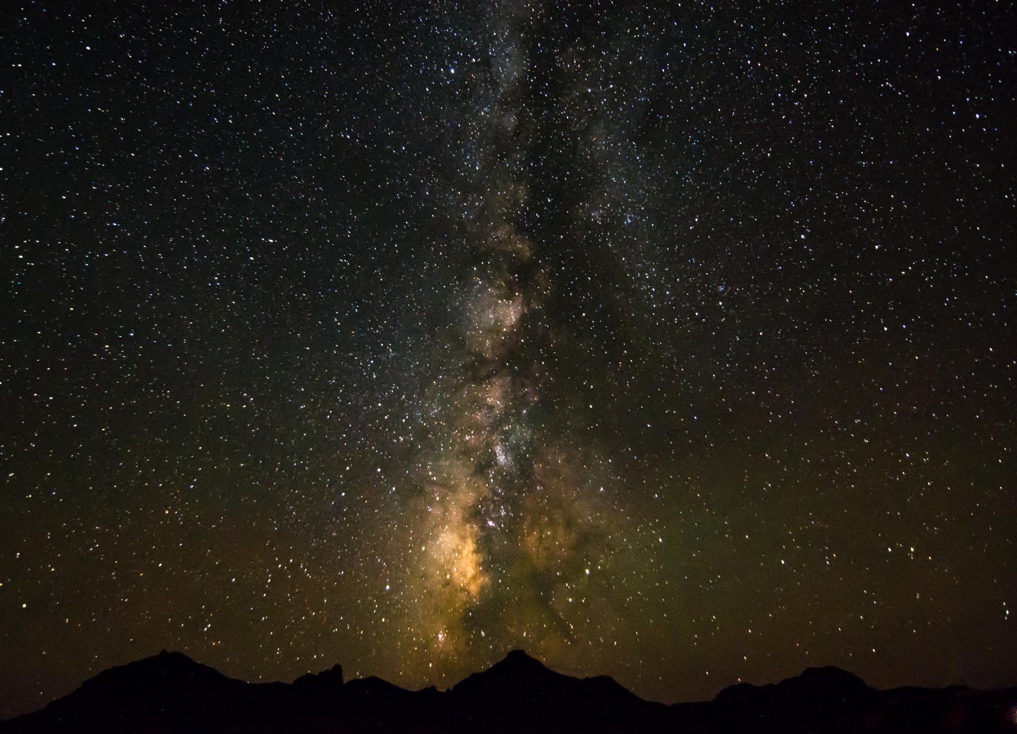 The Milky Way galaxy streaks across the sky.