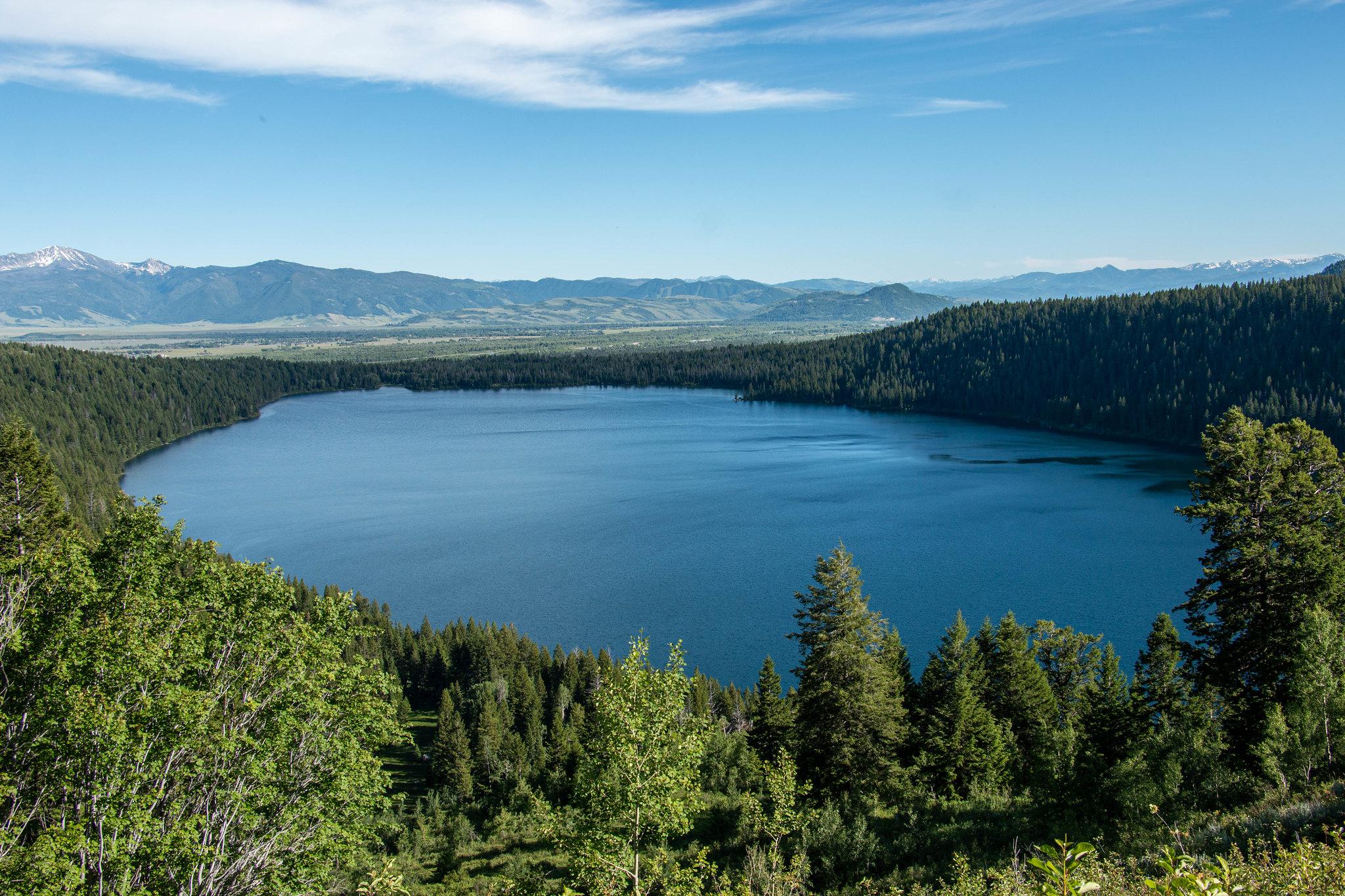 A lake surrounded by trees as viewed from above.