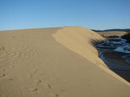 sun setting on sand dunes