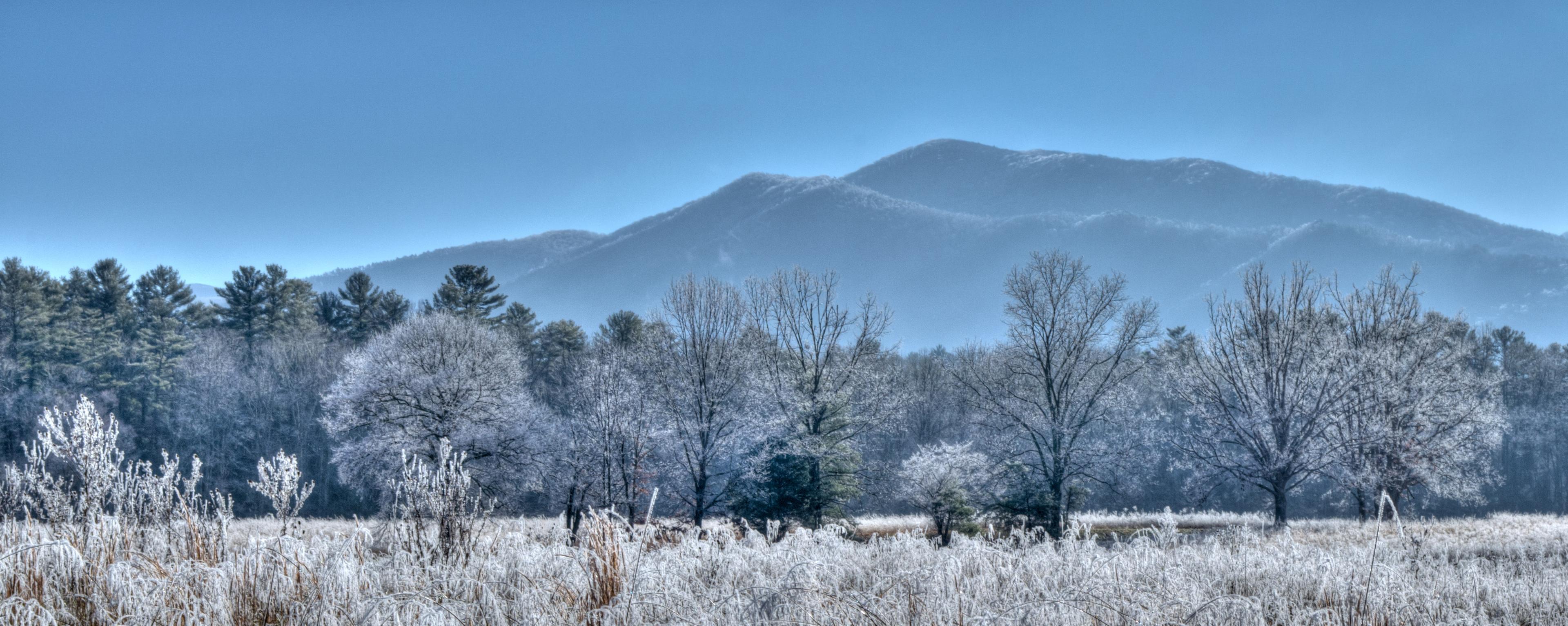 A thick layer of frost covers the fields, trees, and mountains in Cades Cove.