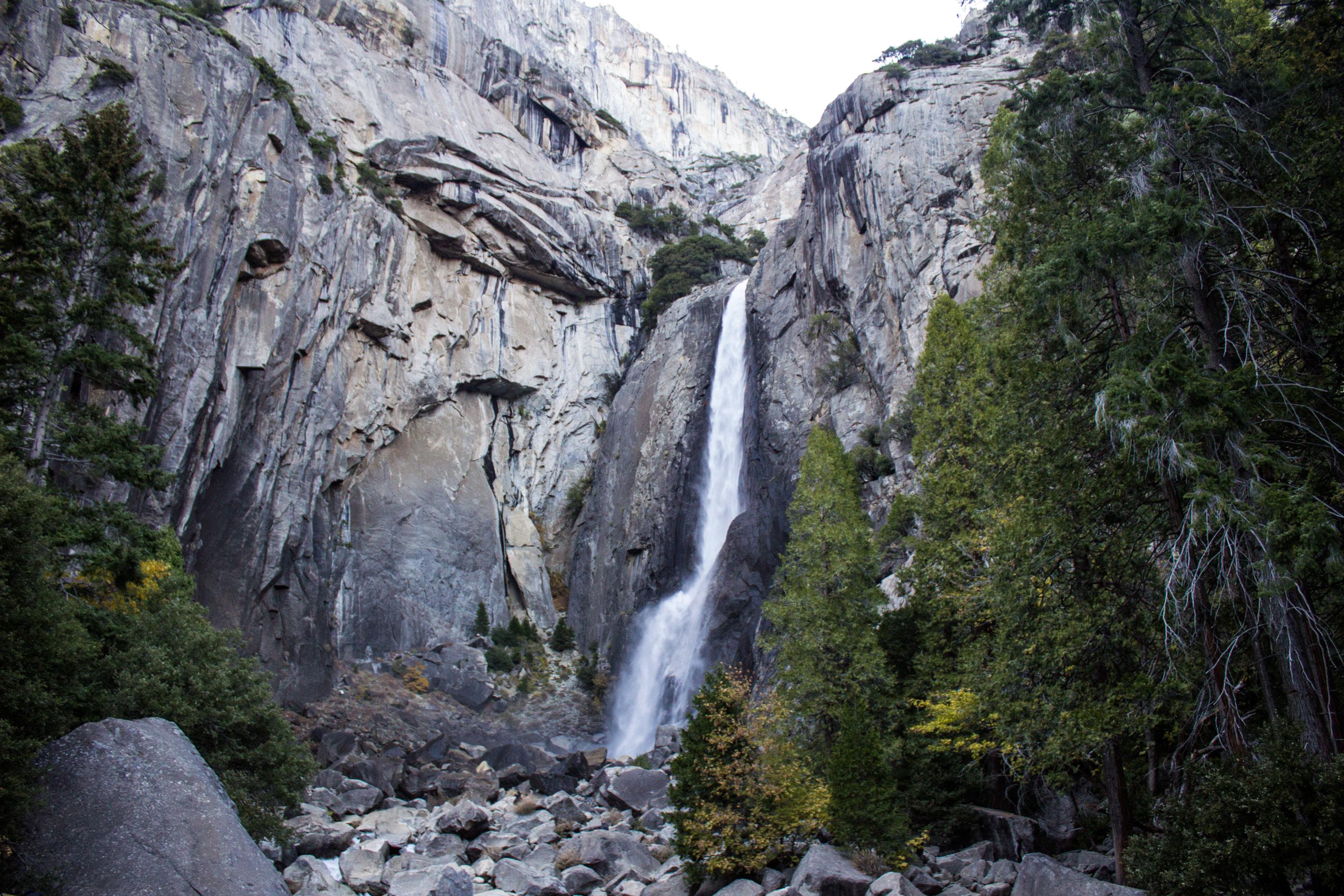 A waterfall flowing down a granite cliff.