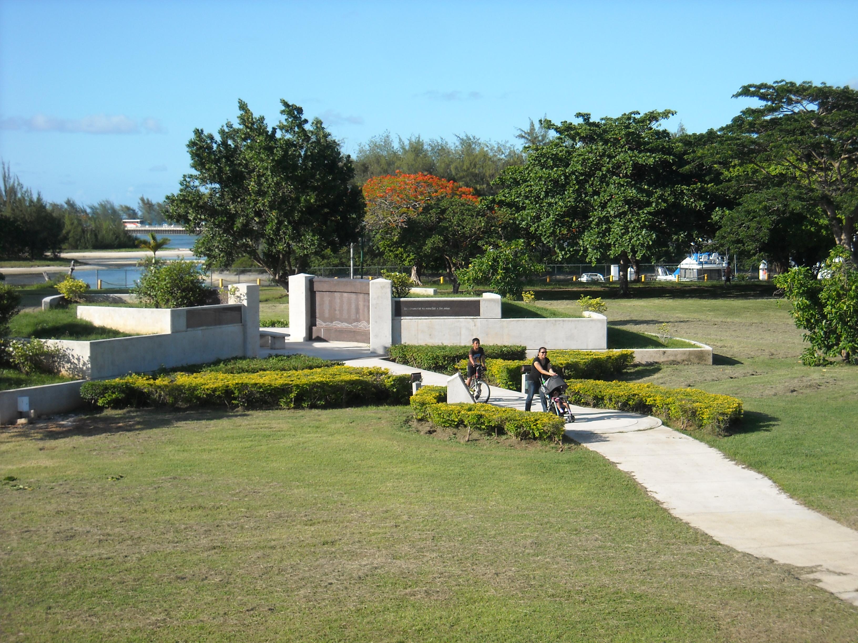 People walking the paths at the American Memorial Park.